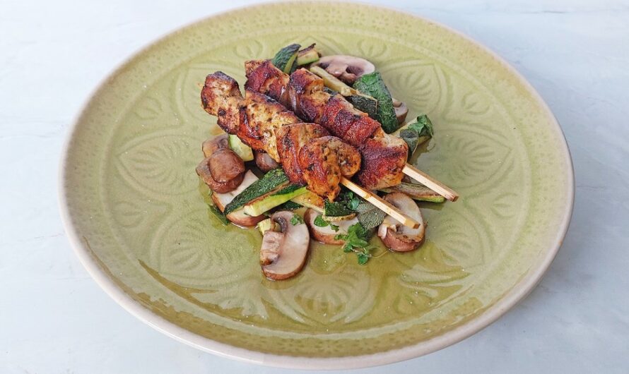 Grilled gyro skewers on a bed of zucchini