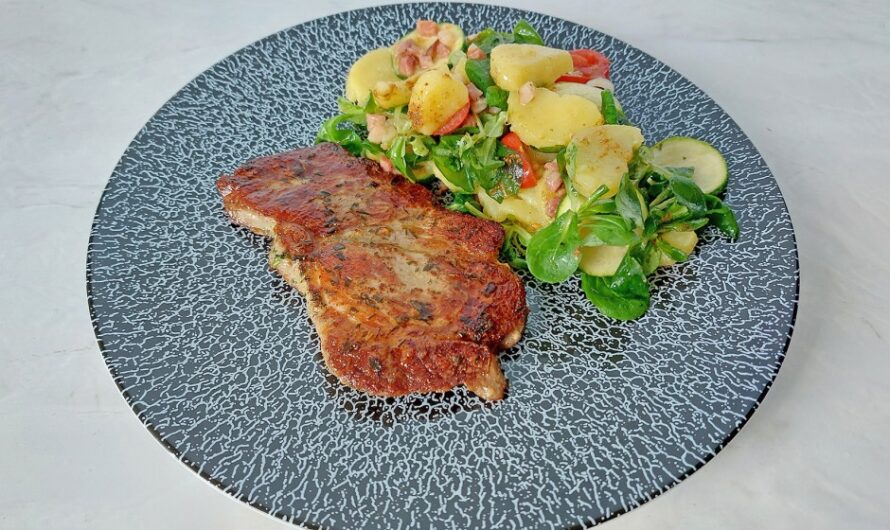 Pork steak with potato-zucchini salad.