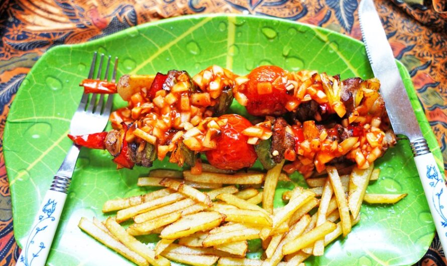 Colorful skewers with onion sauce and French fries