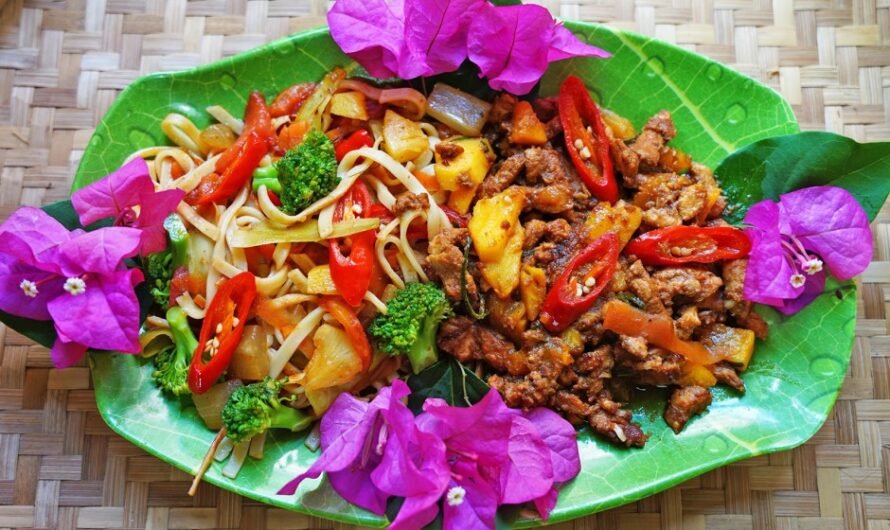 Roasted pork with pineapple on colorful noodles