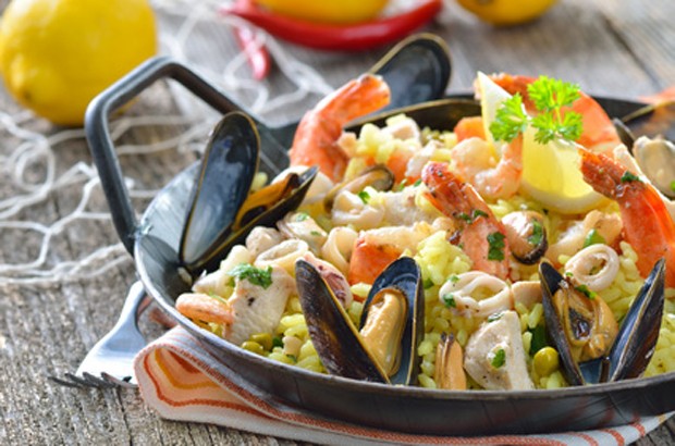 Paella is a traditional Spanish dish made with rice, saffron, vegetables, and a variety of seafood or meat.